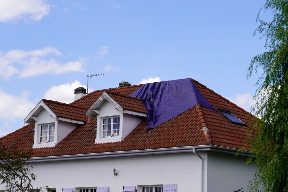House with tarp after a storm